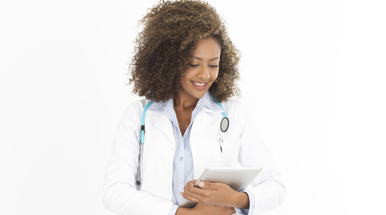 doctor with a stethoscope around her neck looks down at a chart in her hands